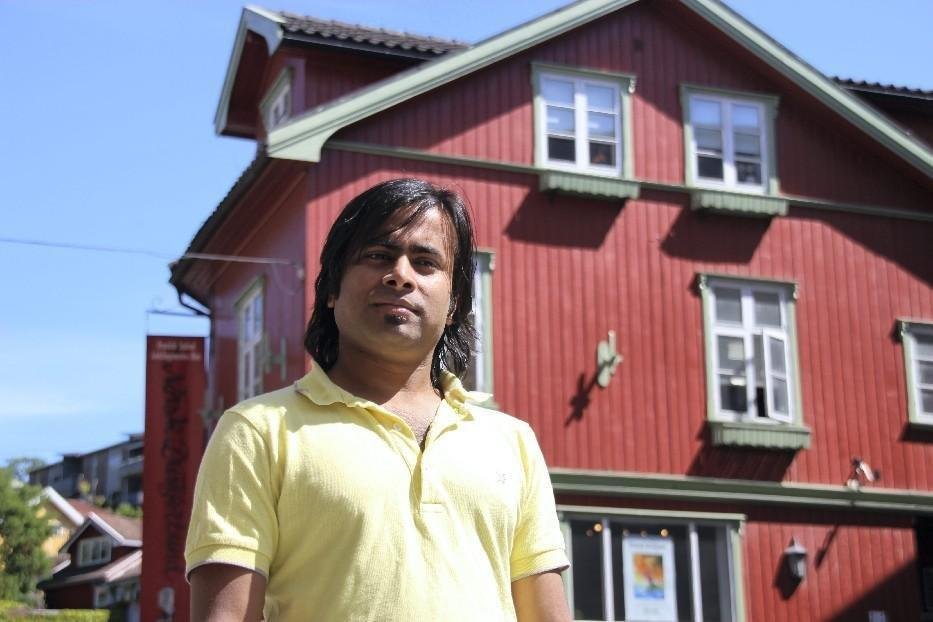 ARiF standing outside a red wooden building in Norway