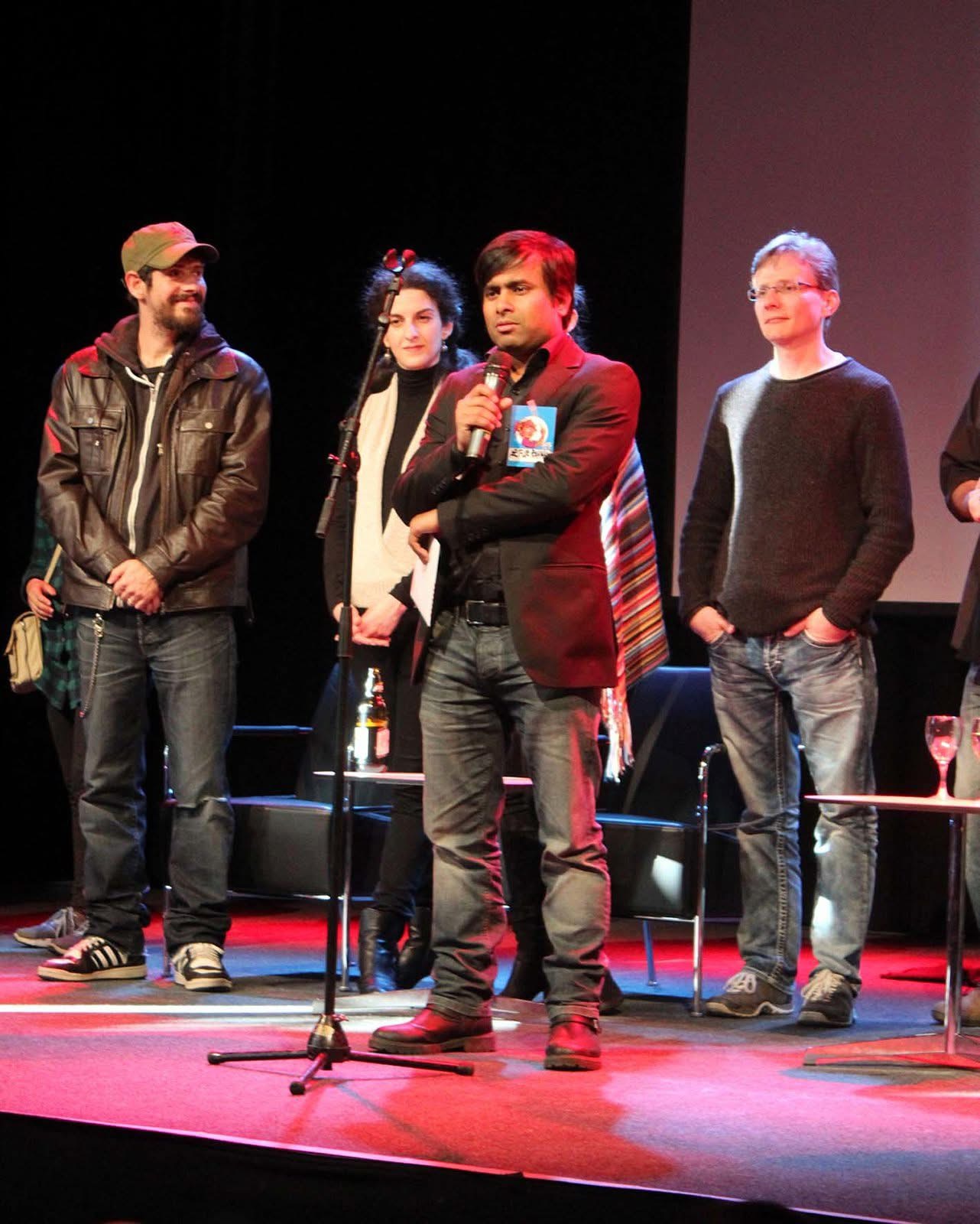 ARiF speaking on stage with fellow guests